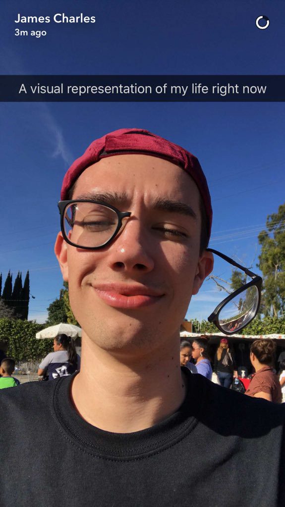 James Charles no makeup and with half a pair of glasses